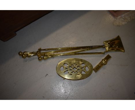 A selection of polished brass fire tools, including footman