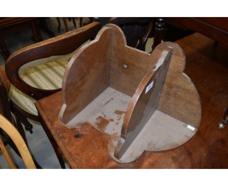 A mid 20th Century oak corner wall shelf of small proportions
