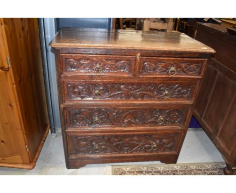 A 19th Century oak chest of two over three drawers, hvaing carved draw fronts and brass ring handles, dimensions approx. W104