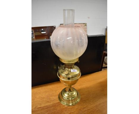 A Victorian style brass oil lamp, with glass chimney and opaque shade