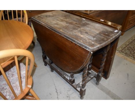 An early to mid 20th Century oak part stripped twist gate leg table