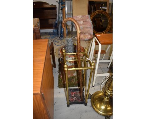 An Edwardian brass four compartment stick stand having cast base, height approx. 63cm