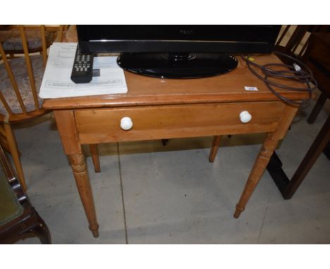 A Victorian stripped pine side table having frieze drawer with ceramic handles, on turned legs, width approx. 74cm depth 45cm