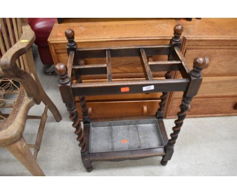 An early 20th Century oak twist frame umbrella/stick stand, including drip tray, approx width 44cm