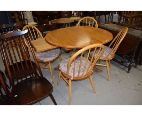 A beautiful Ercol extending table and set of four hoop and stick back chairs, gold badged, length 112cm plus extra 38cm leaf 