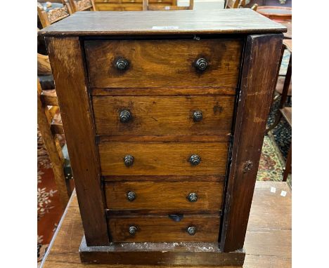 19th century miniature table top mahogany Wellington type chest of five drawers, the interior revealing various clock parts a