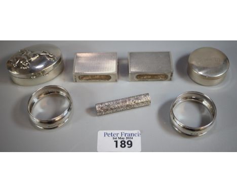 Box of silver to include: two napkin rings, two silver boxes one decorated with jockey and racehorse, two engine turned match