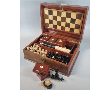 Early 20th century mahogany games compendium, the box containing various chess pieces, card boxes and playing cards, draughts