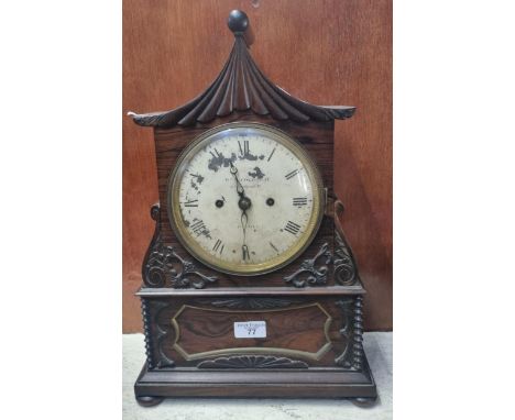 Early 19th century rosewood pagoda shaped two train mantel clock, having painted Roman face marked William Nicoll of London. 