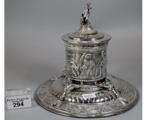 An Elkington's Greek revival silverplated capstan shaped inkwell with figural cover, frieze of battle scenes and griffin and 