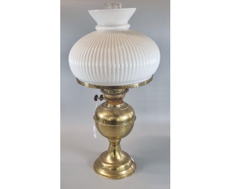 20th century double oil burner lamp with opaline glass fluted shade on a brass reservoir and base.  (B.P. 21% + VAT) 