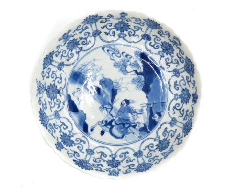 Kangxi, blue and white decor of hunters on horseback, marked with double ring and 6 characters, 20 cm. in diameter, restored.