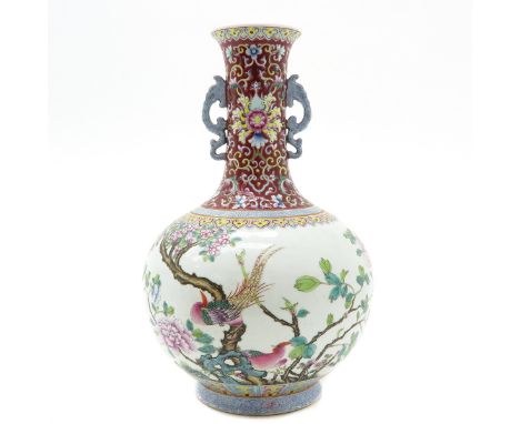 Polychrome decor with ruby background on neck of vase, dragon handles, 34 cm. tall, marked with 6 characters on the bottom.