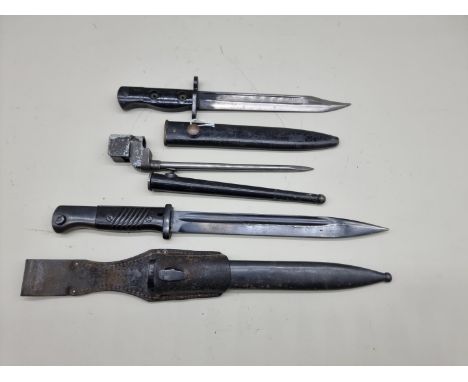 A British SLR L1A3 bayonet and scabbard; together with two other bayonets and scabbards. (3) 