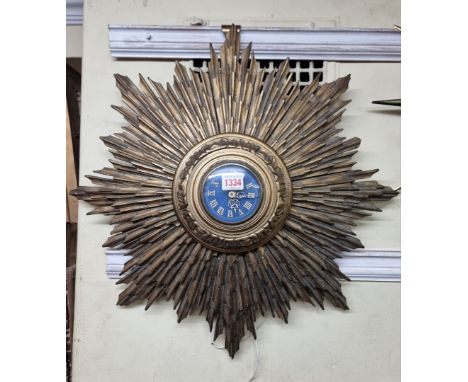 A large vintage gilt plaster starburst wall clock, with Gents brown Bakelite movement, 56cm diameter.&nbsp;&nbsp; 
