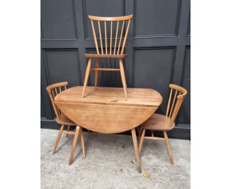 A vintage Ercol drop leaf table and three matching dining chairs, the table 125cm wide when open, (s.d.).&nbsp; 