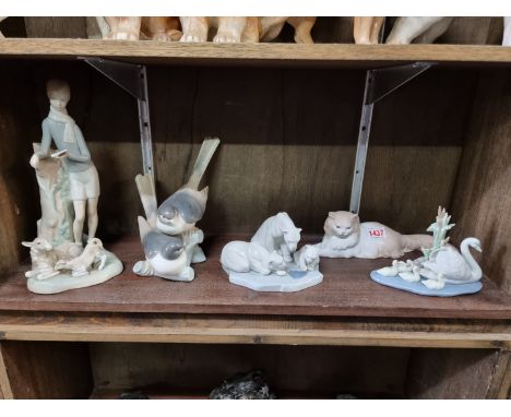 Four Lladro figure groups,&nbsp;largest 27cm high; together with a Nao cat. (5) 