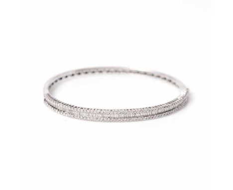 DIAMOND SET BANGLE
set with a row of baguette cut diamonds between two rows of brilliant cut diamonds, the diamonds totalling
