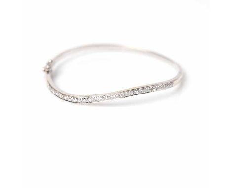 DIAMOND SET BANGLE
of curved form, set with brilliant cut diamonds, in unmarked white gold