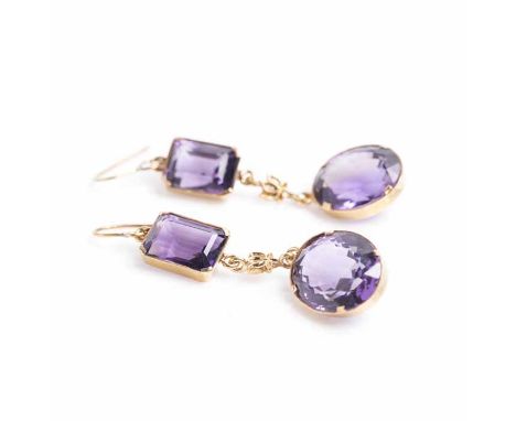 PAIR OF AMETHYST DROP EARRINGS
each with an emerald cut and oval cut amethyst, with a floral design section in between, unmar