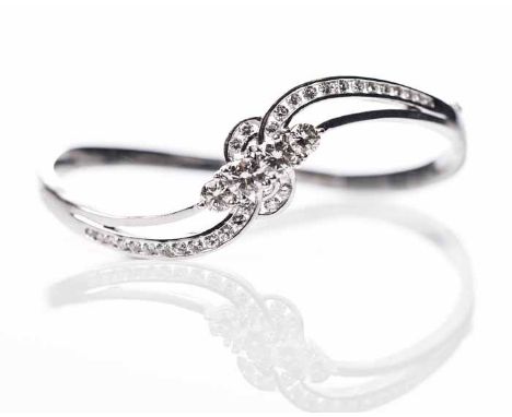 OUTSTANDING WHITE GOLD DIAMOND SET BANGLE
the two central brilliant cut diamonds each measuring approximately 0.5 carats, fla