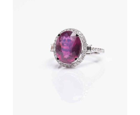 RUBY AND DIAMOND CLUSTER RING
the central oval cut ruby approximately 6.0 carats, surrounded by diamonds totalling approximat