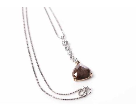 FANCY DIAMOND PENDANT
with a pear cut fancy brown diamond of approximately 8.12 carats, below five graduated white diamonds t