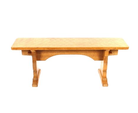 Workshop of Robert (Mouseman) Thompson of Kilburn, an English oak bench with adzed finished top, raised on shaped end support