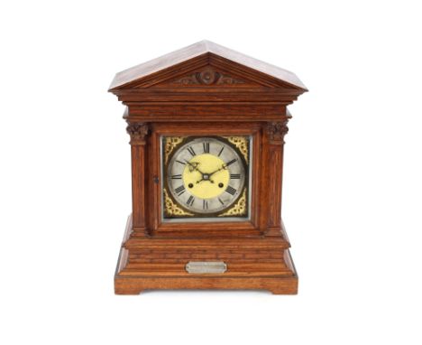 A late Victorian oak cased mantel clock, the case of architectural design enclosing a brass and steel spandrel dial, eight da