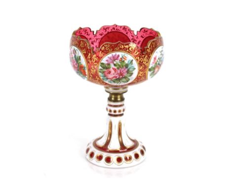 A 19th Century ruby glass overlaid pedestal bowl, the panels with profuse foliate decoration on gilt heightened foliate groun