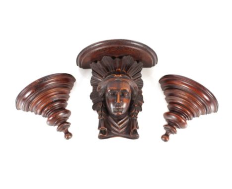 A 19th Century oak wall bracket, the semi-circular shelf supported by a female head, 21.5cm high; and two oak side brackets (