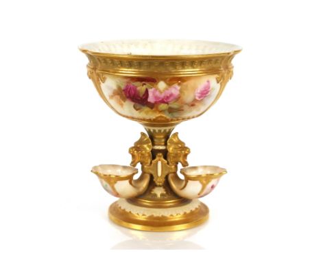 A Royal Worcester table centrepiece decorated with roses within gilt heightened panels, Cornucopia shaped flower holders to t