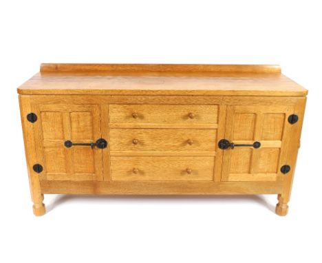 Workshop of Robert (Mouseman) Thompson of Kilburn, an English oak panelled sideboard, fitted three central drawers flanked by