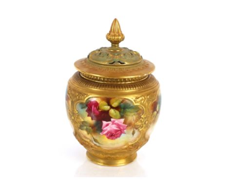 A Royal Worcester Pot Pourrie vase and cover, painted with panels of roses heightened in gilt, the cover surmounted by a flor