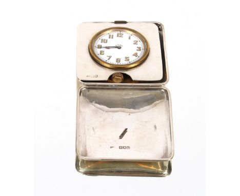 An eight day travelling clock, contained in silver hinged case, London 1915