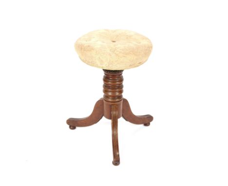 A late Victorian mahogany revolving piano stool, raised on a ring turned baluster column and triple splay terminating in bun 