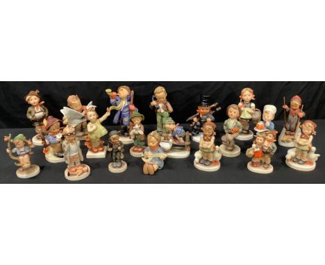 A collection of Goebel Hummel figures including Hear Ye Hear Ye, Hello, The Lost Sheep, Sister, Brother, Skier, Doctor, Lates