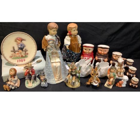 A Goebel Hummel figure group, Madonna and Child, 23cm high; a pair of Goebel dolls; Goebel figures including Happy Pastime, M