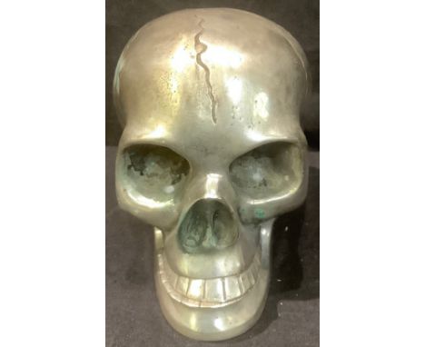 A cast metal model of a human skull, with articulated lower jaw, 9.5cm high 