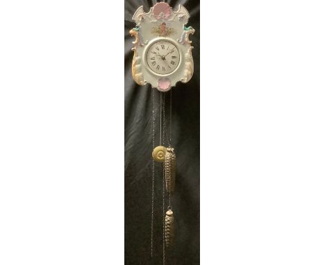 A late 19th century Continental porcelain wall clock, Roman numerals on white enamel dial, the case 25cm high 