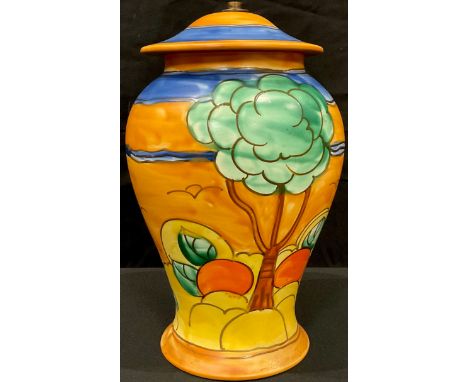 An Art Deco Crown Devon inverted baluster table lamp, tube lined with tall trees and ripe oranges, in shades of blue, green a