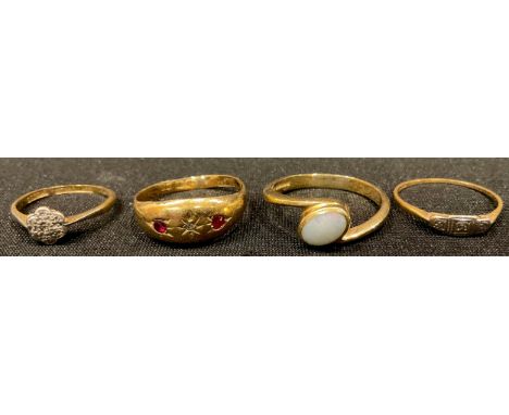 An 18ct gold diamond and ruby chip ring, size P; another 18ct gold ring, set with a single polished oval opal, size R; two 18