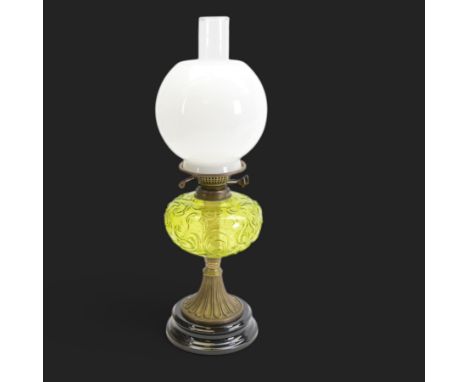 Victorian oil lamp with milk glass shade of baluster form, with green glass reservoir upon a fluted brass stem and stepped ci