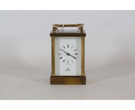An Imperial brass carriage clock, with white enamel dial and roman numerals. Back plate marked Feria, London 11 jewels with o