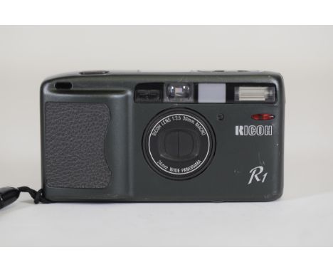 Ricoh R1 35mm Compact Camera - Untested, Ideal for Parts - Note on Back with Camera IssuesThis is a Ricoh R1 35mm compact cam