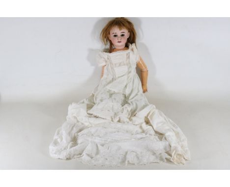 Vintage German Armand Marseille Doll - AM 10 DEP 1894This lot includes a vintage German Armand Marseille Doll, specifically t