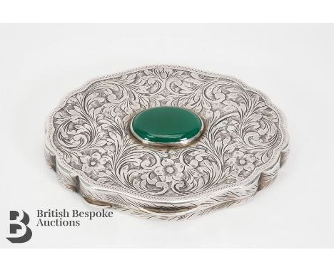 Art Deco silver compact. The mirrored compact having a foliate engraved case set with a green hardstone, stamped 800, approx 