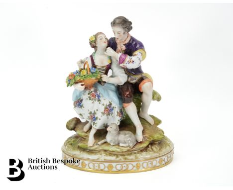 Continental figural group, courting couple with a lamp at their feet, approx 23 cms h, blue factory mark to base.&nbsp;