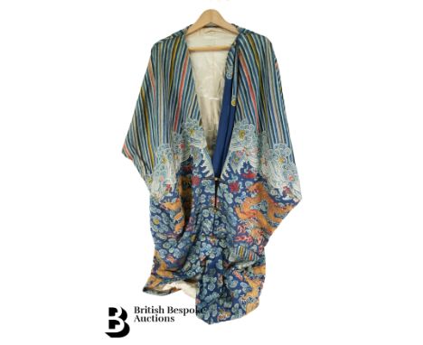 Chinese imperial blue ground silk embroidered tunic, 19th century. The front opening tunic, embroidered with gilt metallic fi