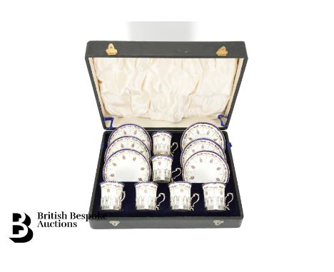 A boxed Royal Worcester coffee set, the cans enclosed in silver holders, London hallmark dated 1916, mm Charles &amp; Richard